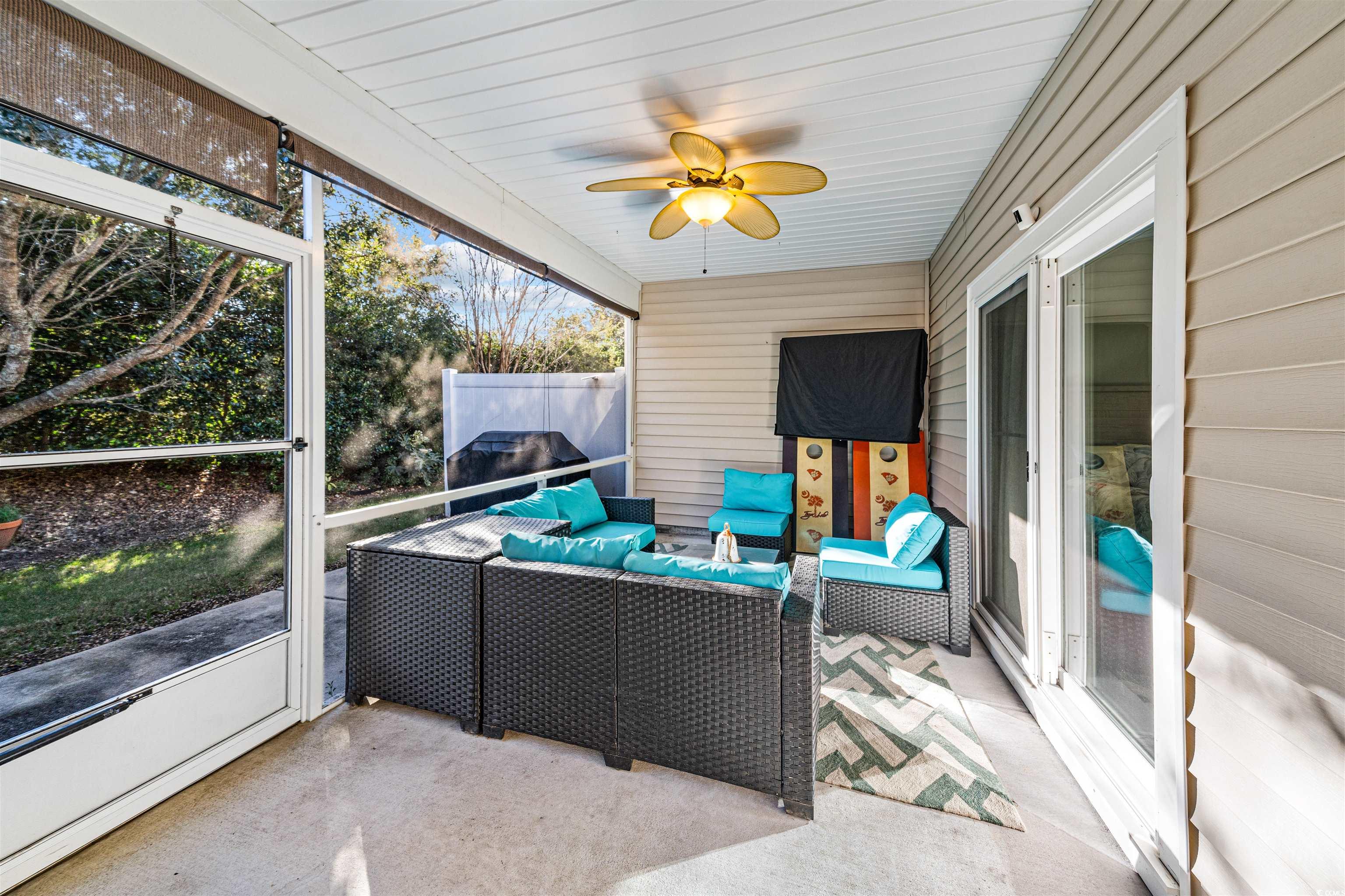 136 Parmelee Drive, Unit C Murrells Inlet, SC 29576 - Photo 23 of 40 Sunroom featuring an outdoor hangout area and ceiling fan