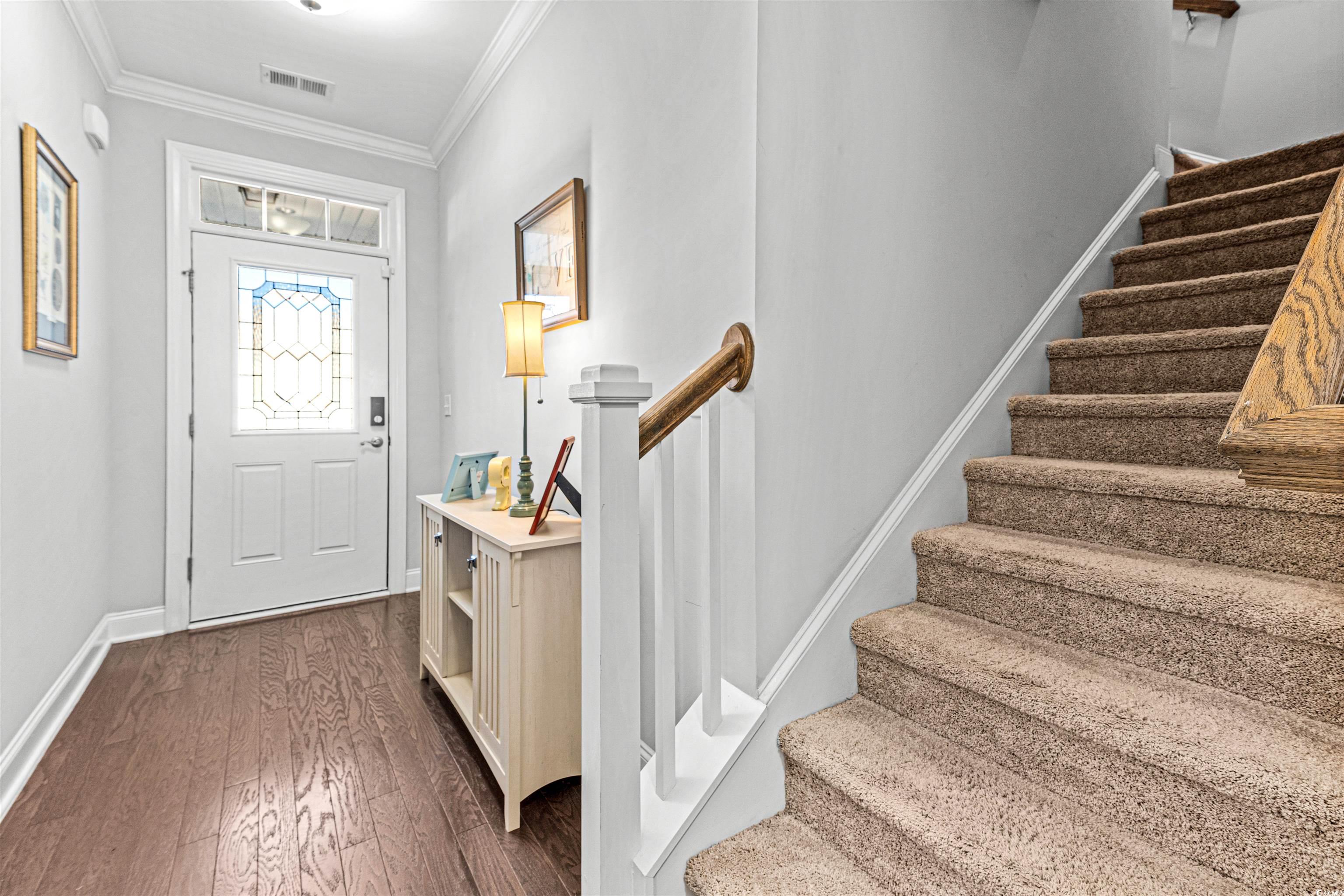 136 Parmelee Drive, Unit C Murrells Inlet, SC 29576 - Photo 3 of 40 Entryway featuring stairs, dark wood-style flooring, and crown molding