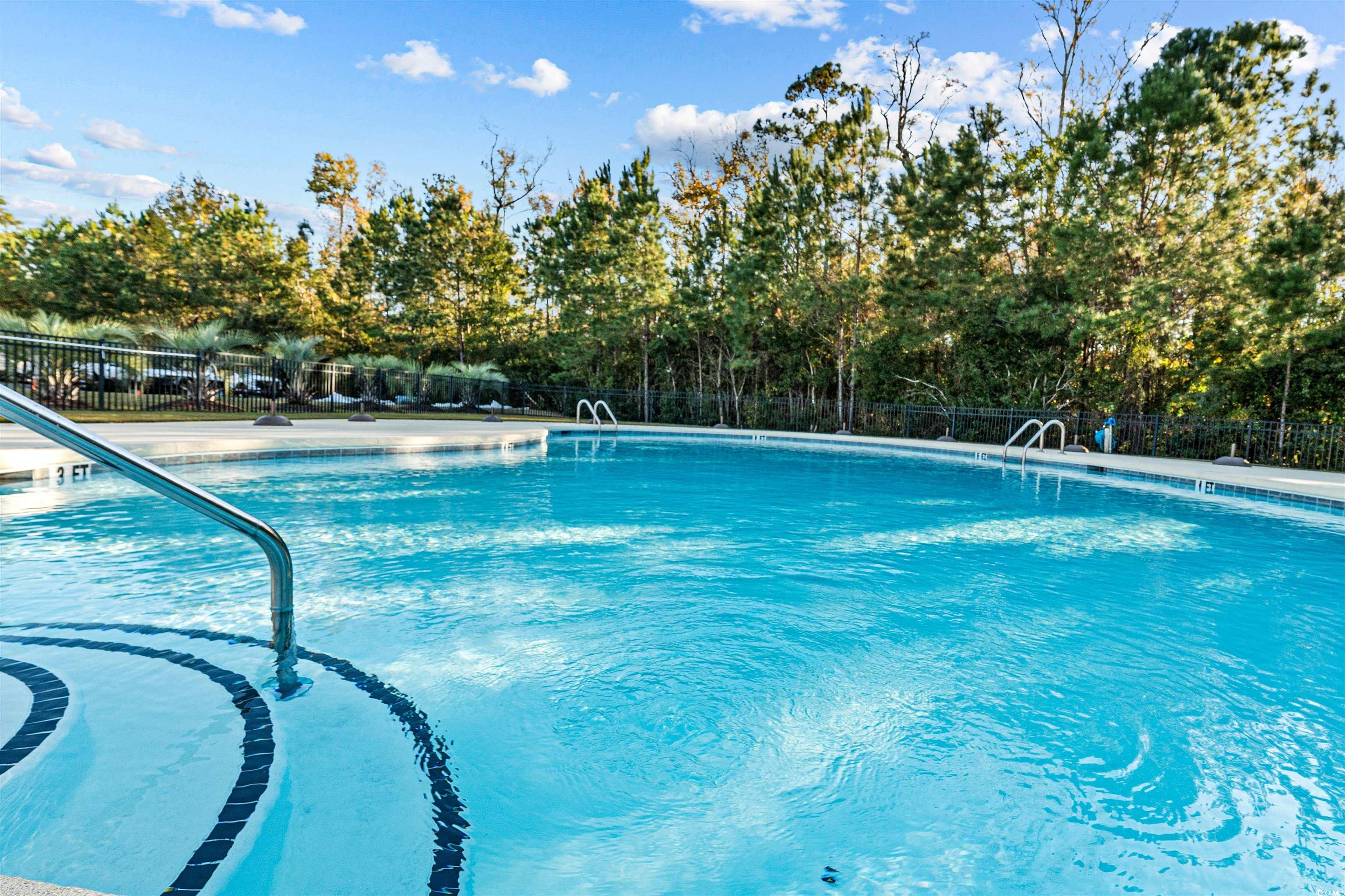 136 Parmelee Drive, Unit C Murrells Inlet, SC 29576 - Photo 33 of 40 Community pool with view of scattered trees and a patio