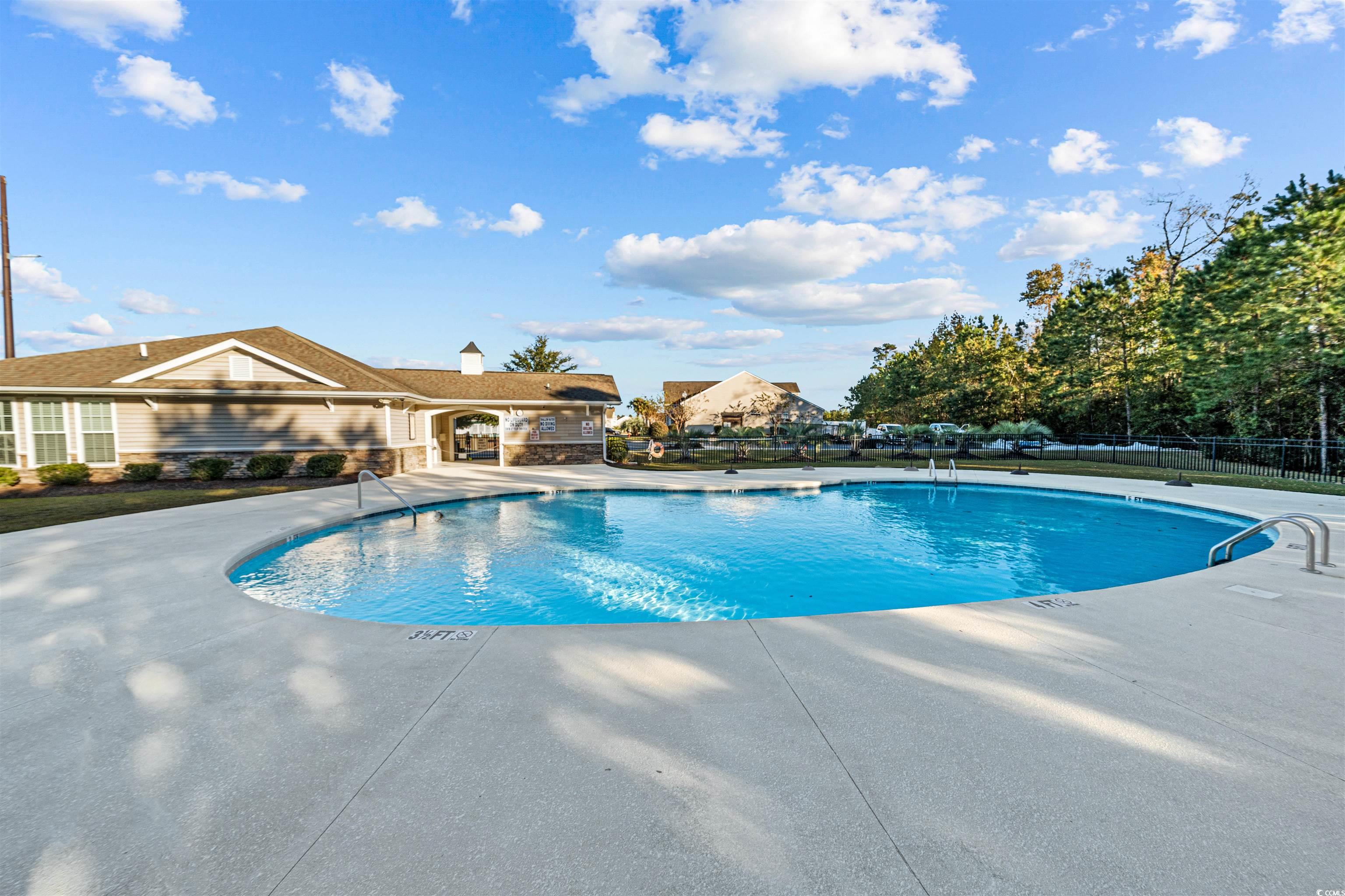 136 Parmelee Drive, Unit C Murrells Inlet, SC 29576 - Photo 34 of 40 Community pool featuring a patio area