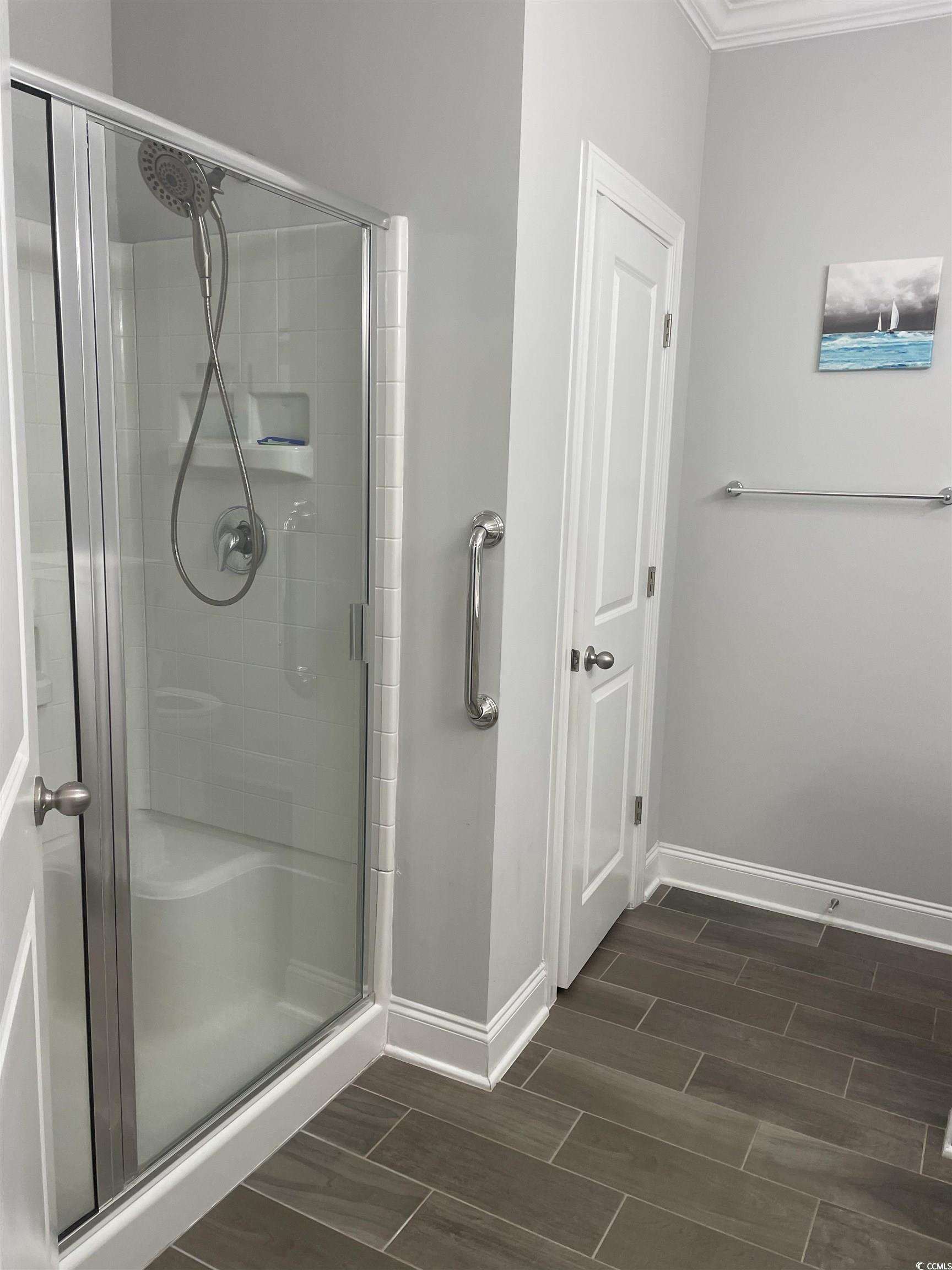 136 Parmelee Drive, Unit C Murrells Inlet, SC 29576 - Photo 39 of 40 Bathroom featuring a shower stall, wood tiled floors, and ornamental molding