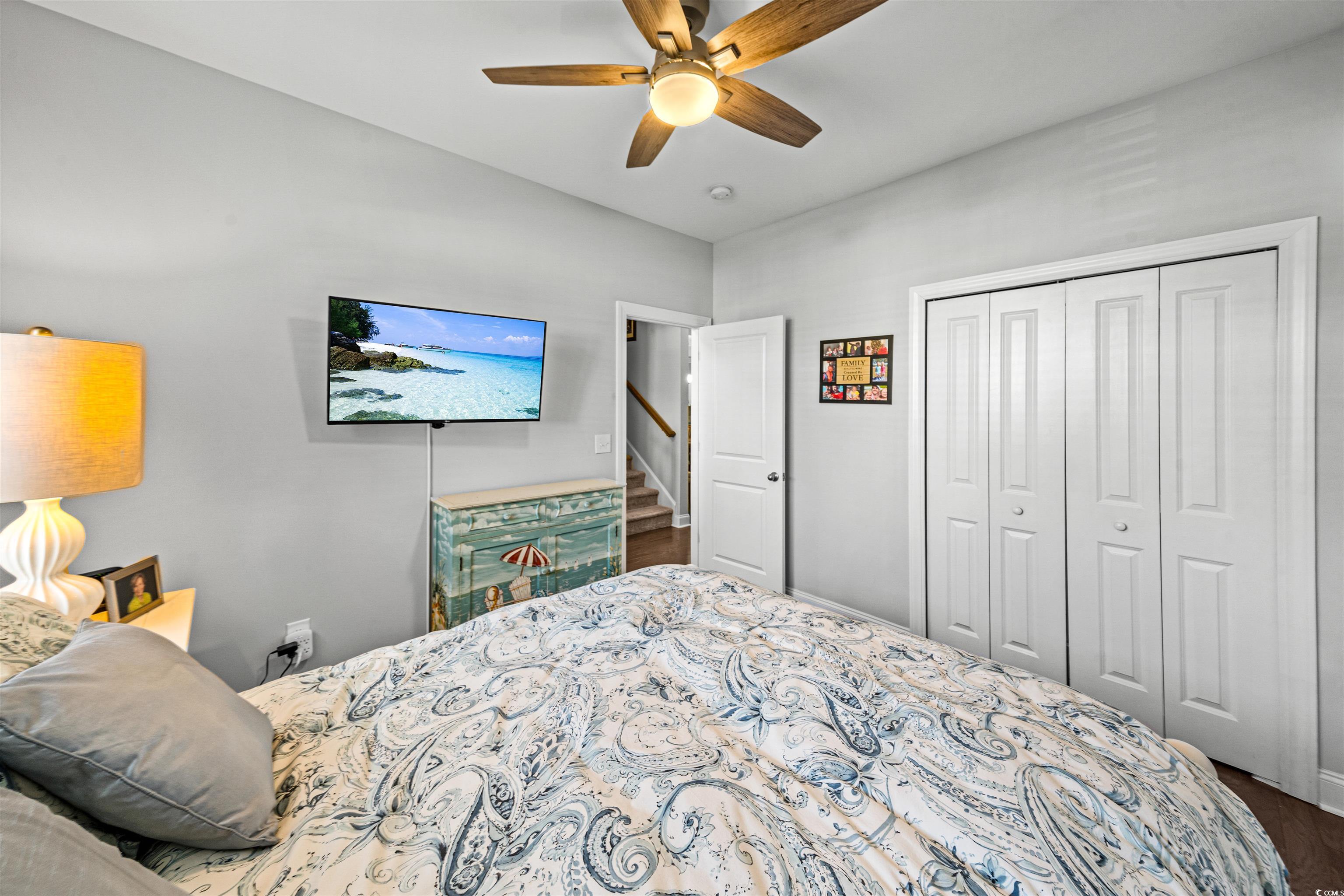 136 Parmelee Drive, Unit C Murrells Inlet, SC 29576 - Photo 5 of 40 Bedroom featuring a closet, a ceiling fan, and wood finished floors