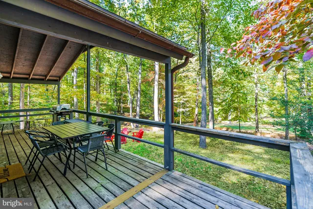 a view of a balcony with furniture and wooden floor
