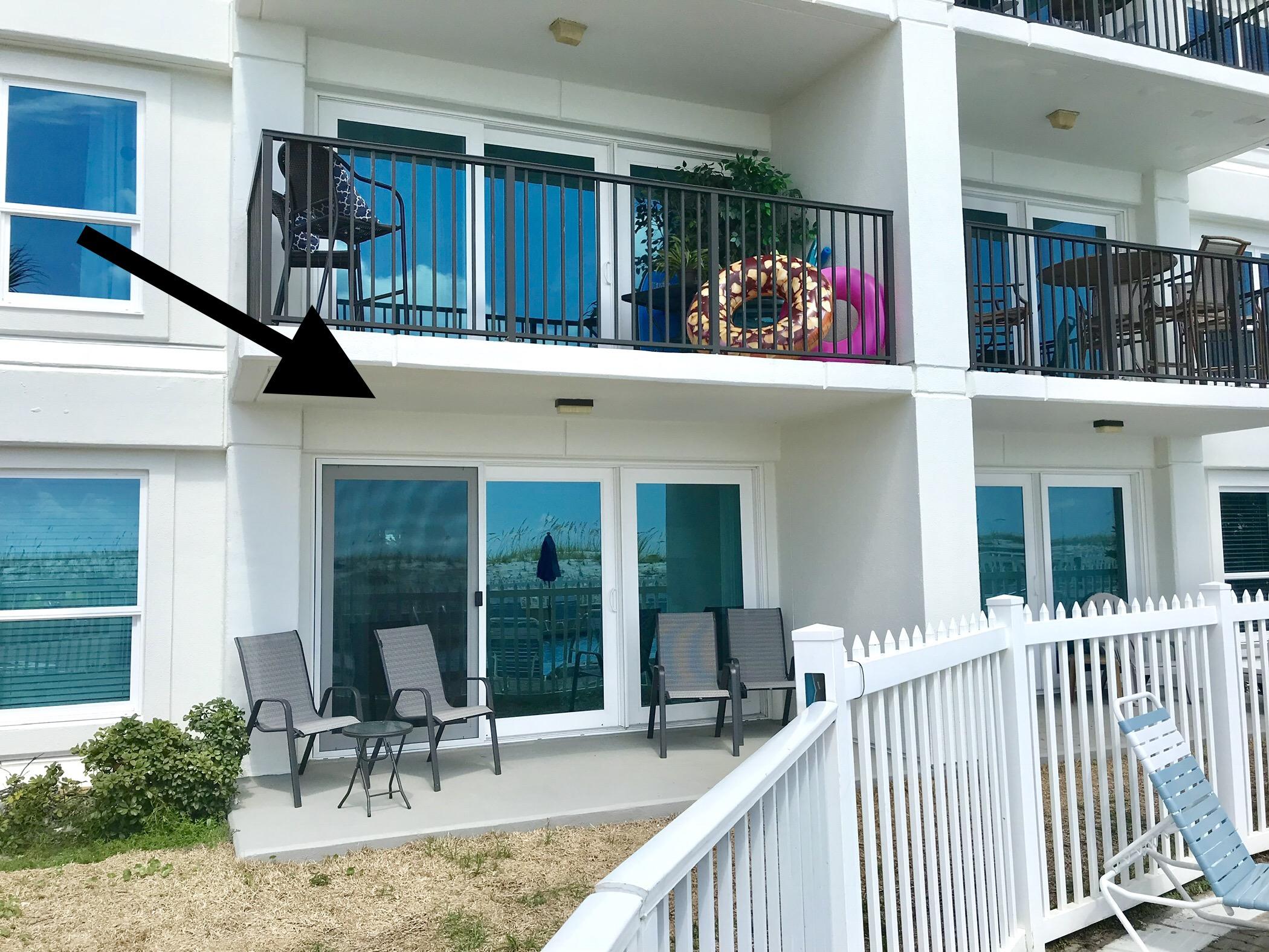 1114 Santa Rosa Boulevard, Unit 102 Fort Walton Beach, FL 32548 - Photo 2 of 23 a man sitting on a bench in front of house
