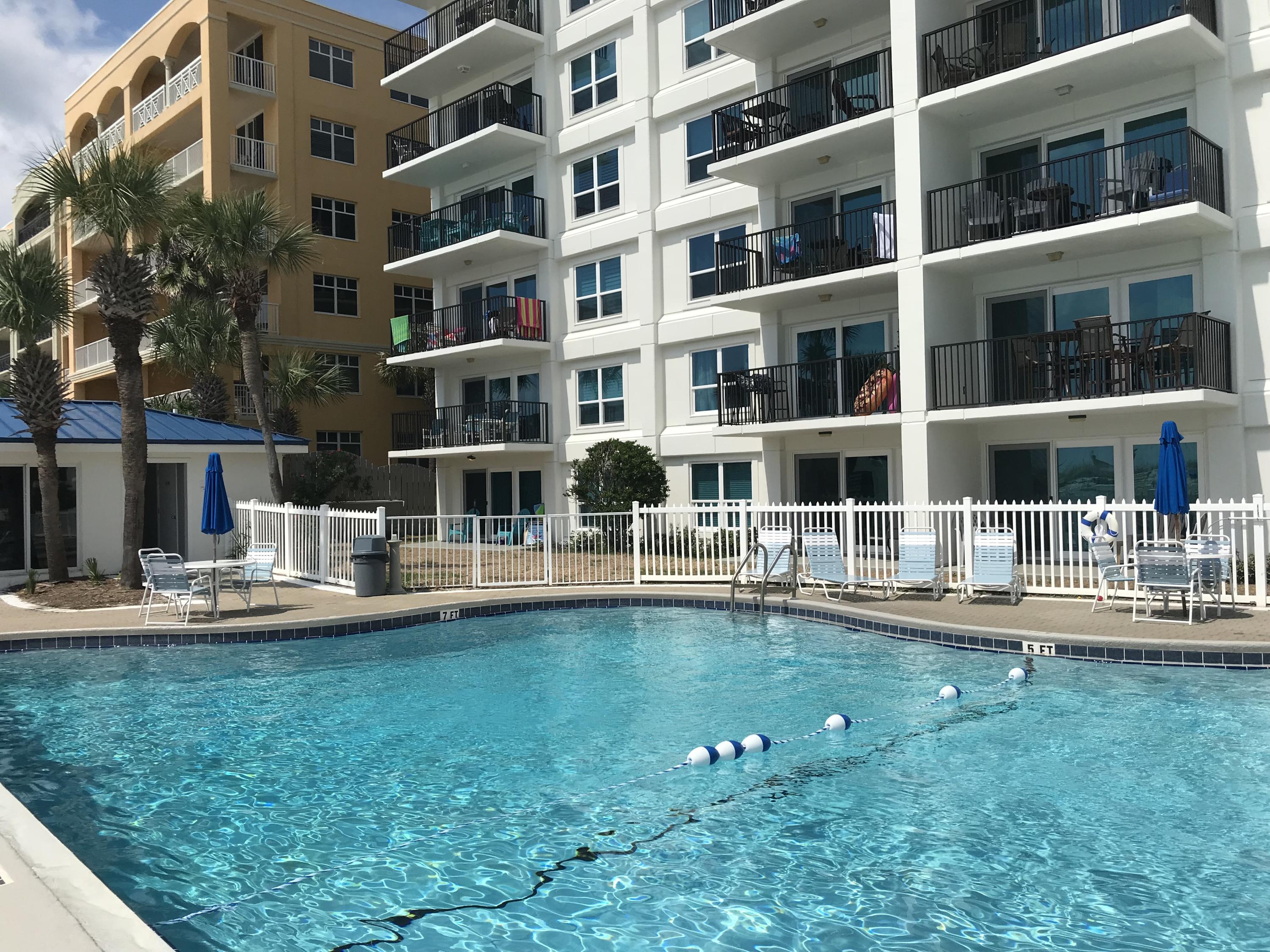 1114 Santa Rosa Boulevard, Unit 102 Fort Walton Beach, FL 32548 - Photo 9 of 23 a house view with swimming pool and chairs