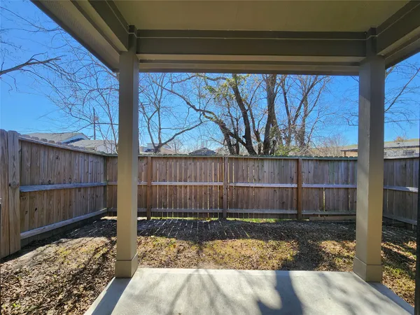 a view of a backyard with wooden fence