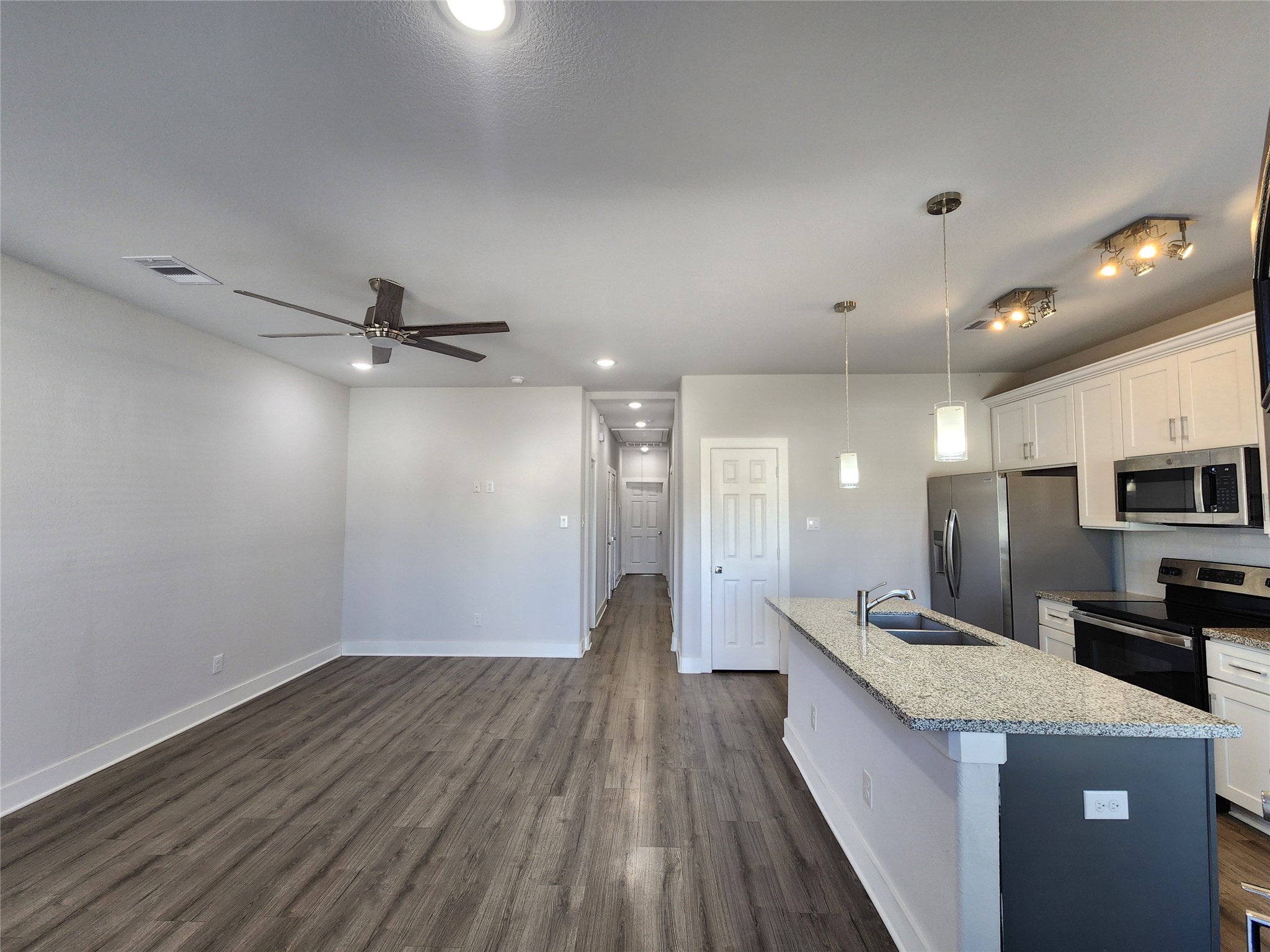 9710 Tuffly Street, Unit B Houston, TX 77029 - Photo 4 of 14 a view of a kitchen with a sink and wooden floor