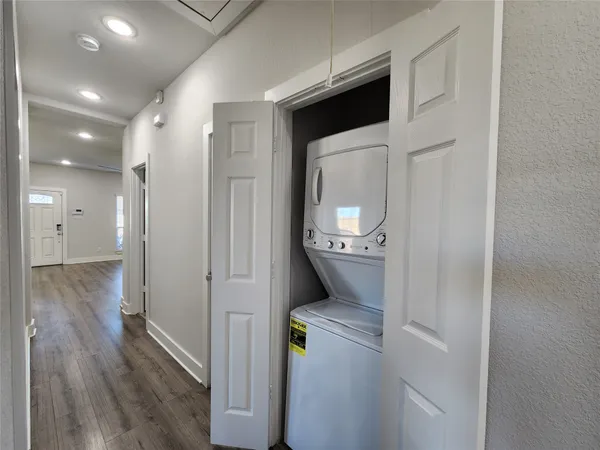 a storage room with wooden floor washer and dryer