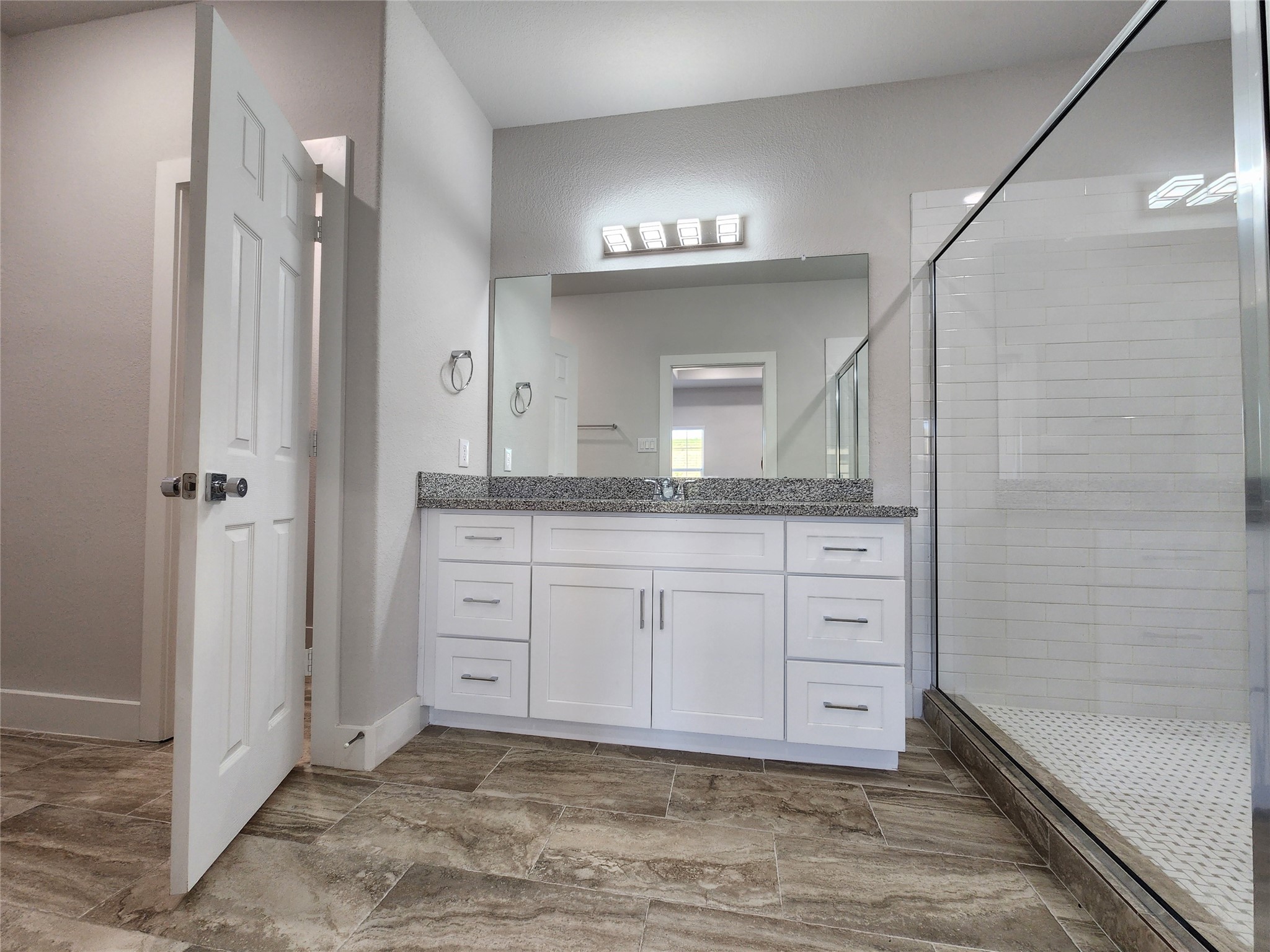 9710 Tuffly Street, Unit B Houston, TX 77029 - Photo 8 of 14 a bathroom with a granite countertop sink mirror and cabinets