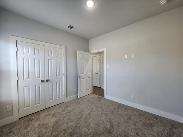 a view of an empty room and closet area