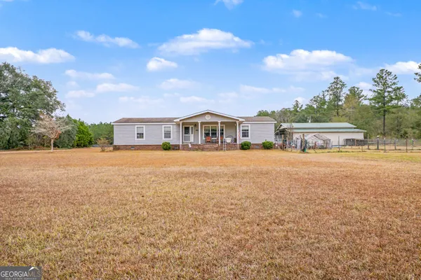 a view of house with yard