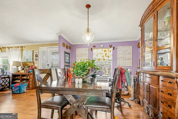 a dining room with furniture and wooden floor