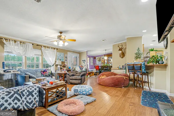 a living room with furniture a chandelier and a large window