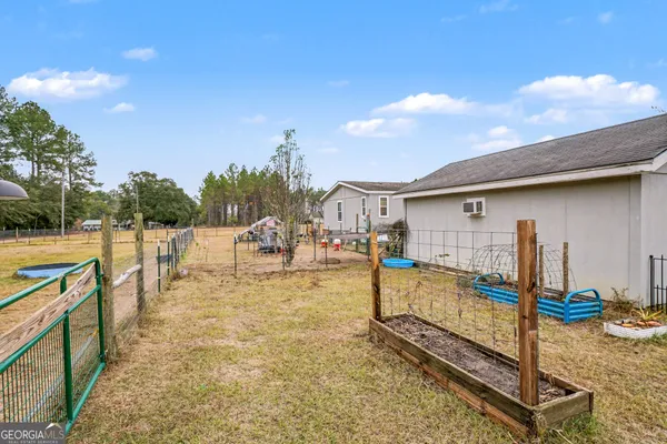 a view of a backyard with swimming pool