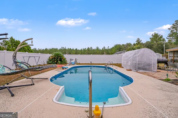 a view of swimming pool with outdoor seating and city view