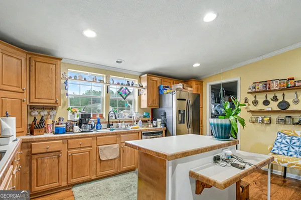 a kitchen with a stove a refrigerator and a dining table
