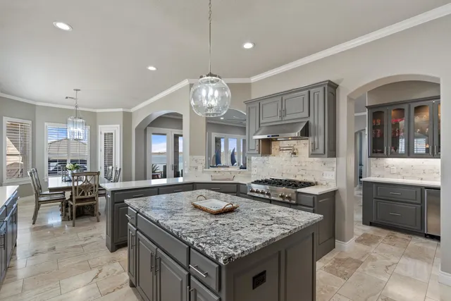 a kitchen with center island table and chairs in it