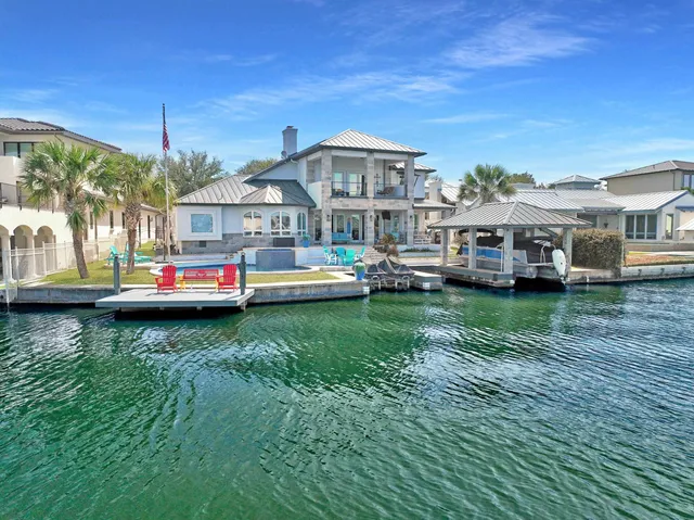 a front view of a house with a garden and trees