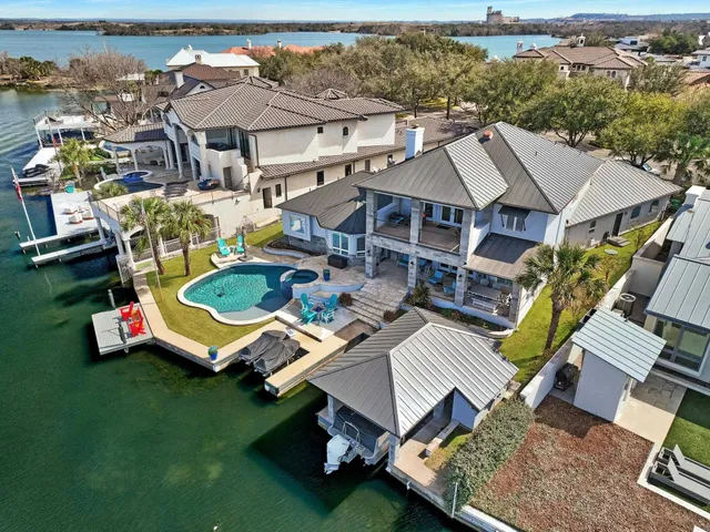 an aerial view of multiple houses with a big yard