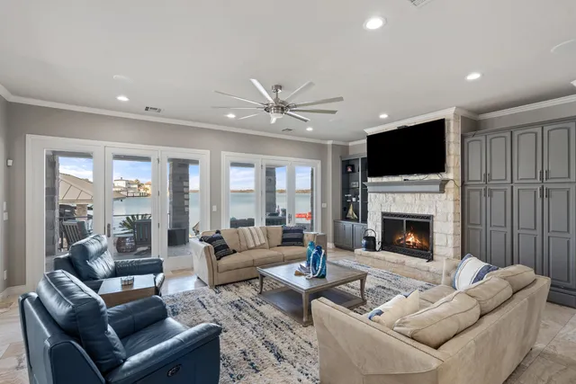 a living room with furniture a fireplace and a flat screen tv