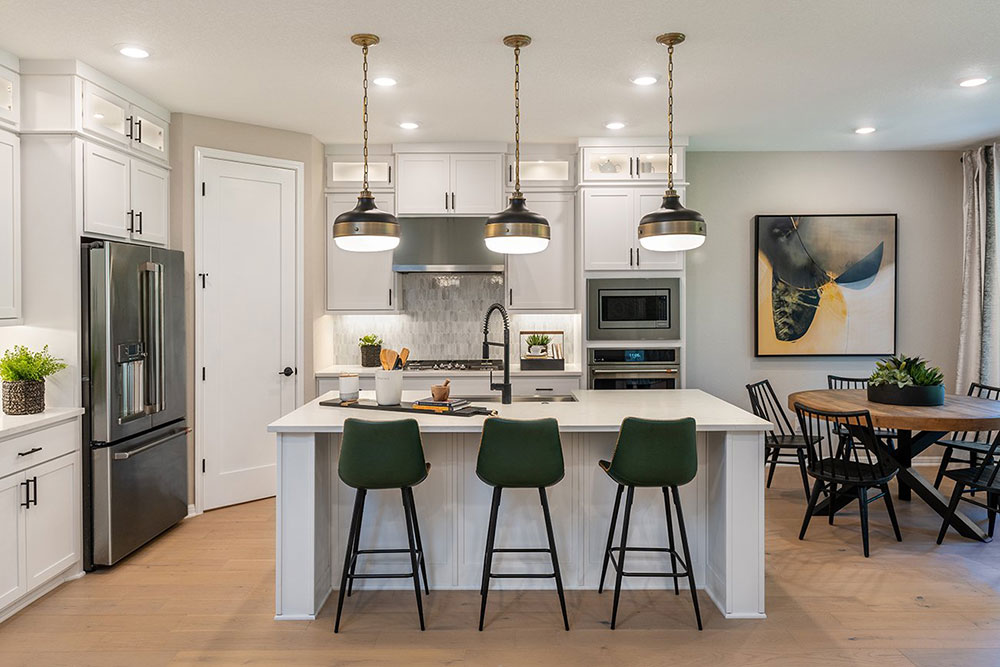 1212 Scenic Grn Loop Georgetown, TX 78628 - Photo 27 of 36 a kitchen with stainless steel appliances granite countertop a refrigerator a stove a kitchen island a dining table and chairs