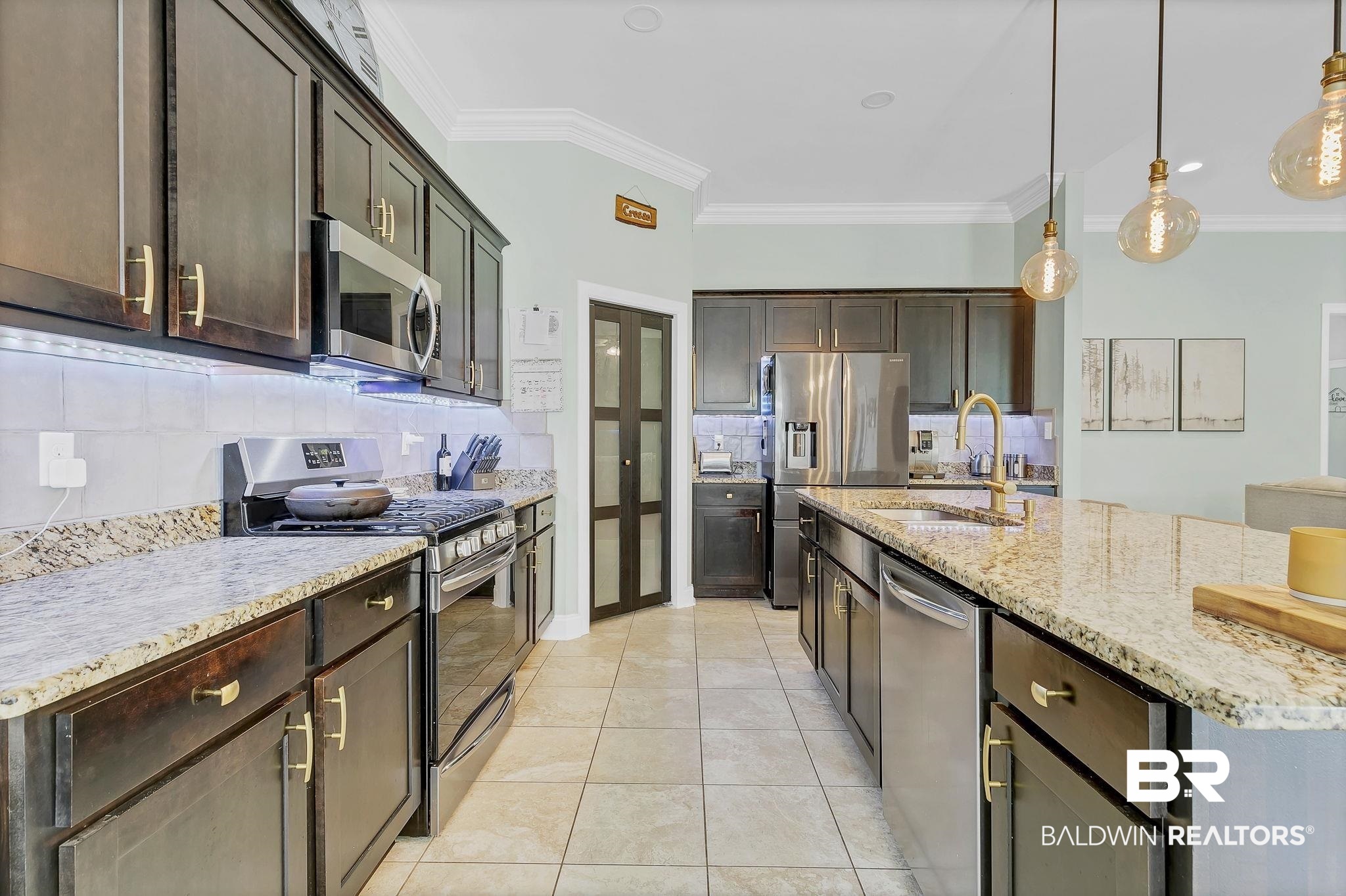30635 Drayton Court Daphne, AL 36527 - Photo 17 of 51 Kitchen featuring stainless steel appliances, a sink, backsplash, ornamental molding, and dark brown cabinets
