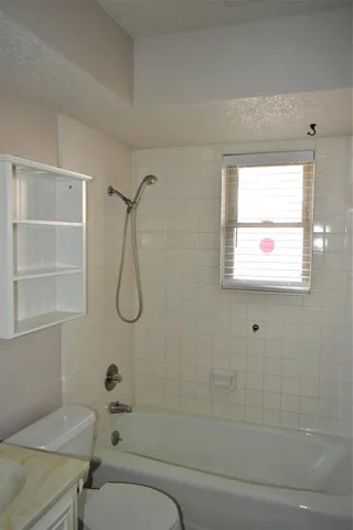 a bathroom with a bathtub and shower