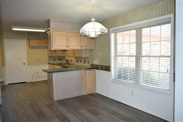 a kitchen that has a sink and a stove top oven