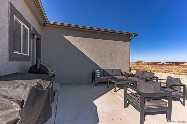 a terrace of a house with outdoor seating