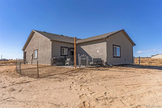 a view of a house with snow on the road