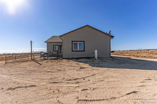 a house view with a wooden fence