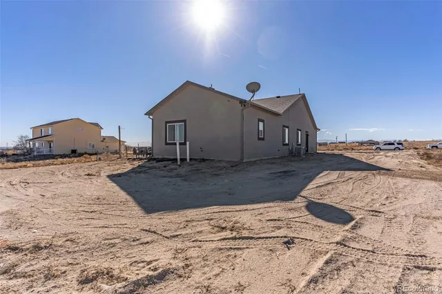 a view of a house with a yard covered in snow