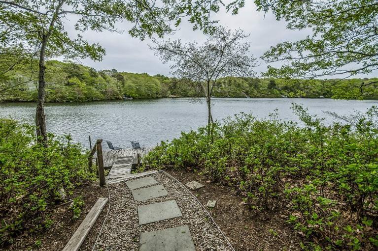 70 Fells Pond Road Mashpee, MA 02649 - Photo 1 of 34 a backyard of a house with lots of green space
