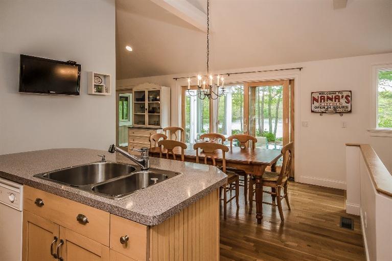 70 Fells Pond Road Mashpee, MA 02649 - Photo 12 of 34 a kitchen with a table chairs and flat screen tv