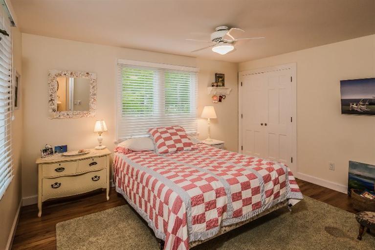 70 Fells Pond Road Mashpee, MA 02649 - Photo 23 of 34 a bedroom with a bed and a table in it