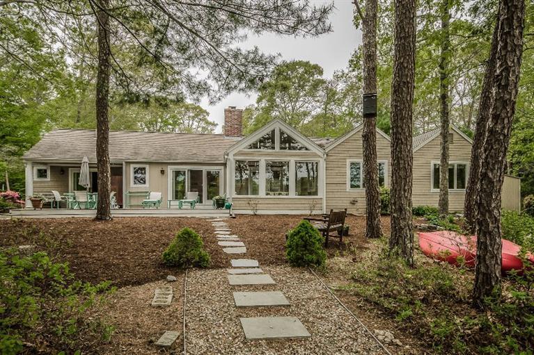 70 Fells Pond Road Mashpee, MA 02649 - Photo 30 of 34 a front view of a house with a yard and trees