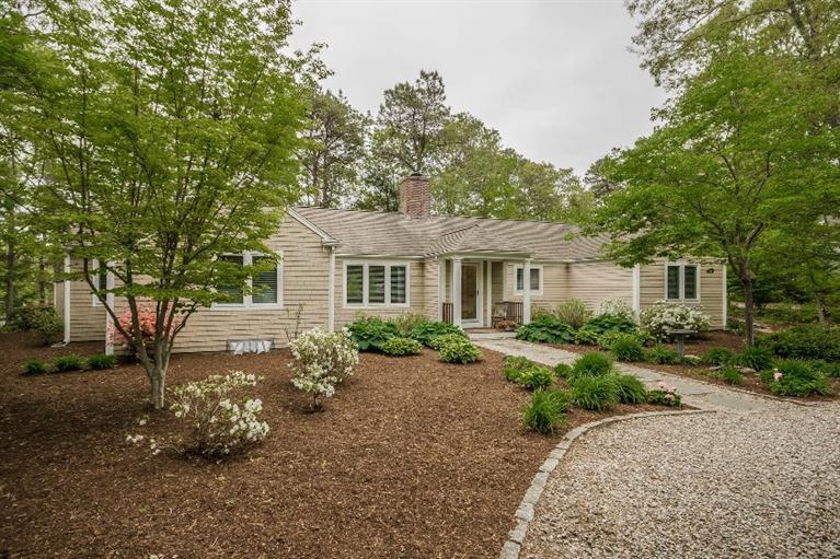 70 Fells Pond Road Mashpee, MA 02649 - Photo 3 of 34 a front view of a house with a garden