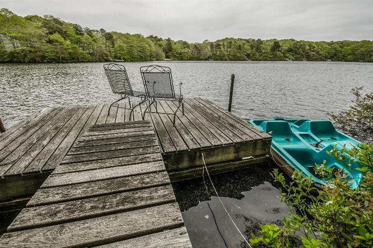 70 Fells Pond Road Mashpee, MA 02649 - Photo 5 of 34 a view of a lake with table and chairs