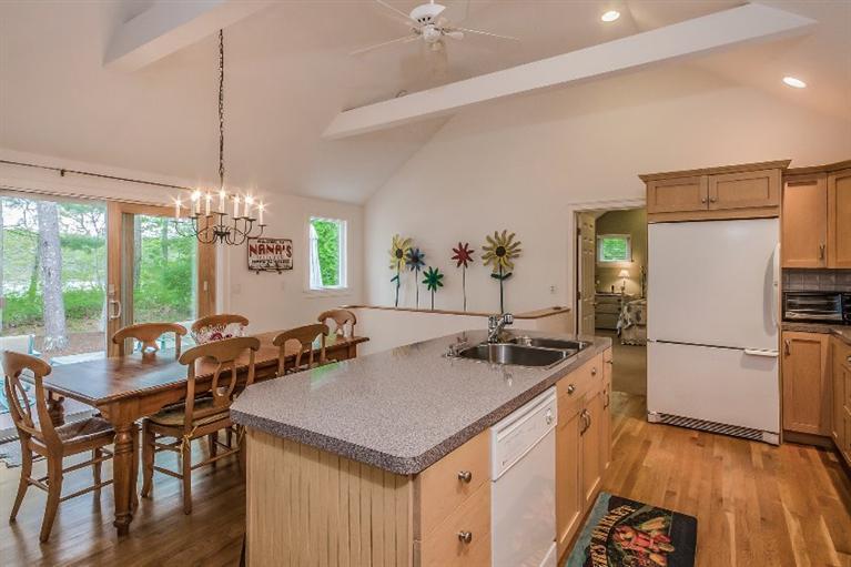 70 Fells Pond Road Mashpee, MA 02649 - Photo 10 of 34 a kitchen with a table chairs refrigerator and microwave