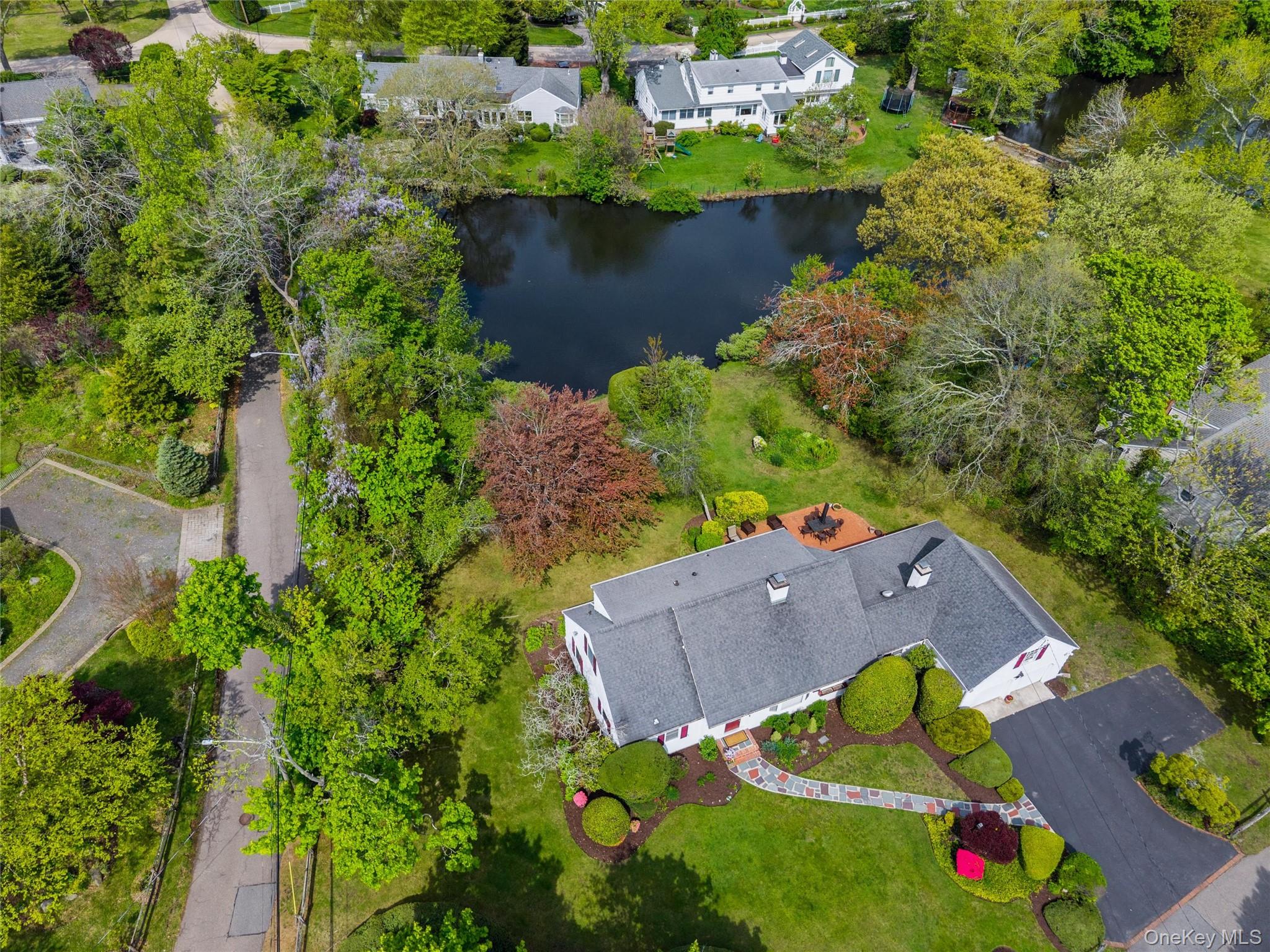 50 Belton Road Babylon, NY 11702 - Photo 2 of 34 This view shows the ample parking. patio and the freshwater pond in backyard.