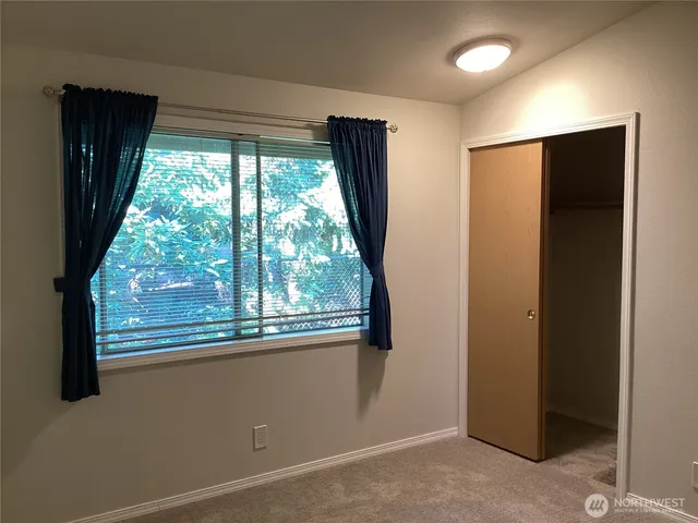an empty room with wooden floor and a window