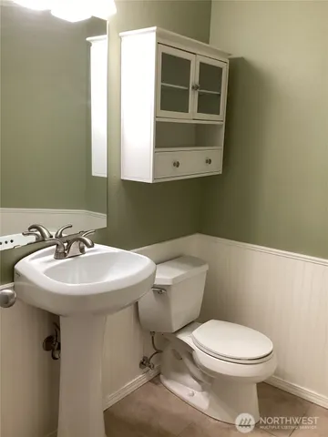 a bathroom with a sink a mirror and a toilet