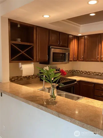 a kitchen with a sink and a stove top oven