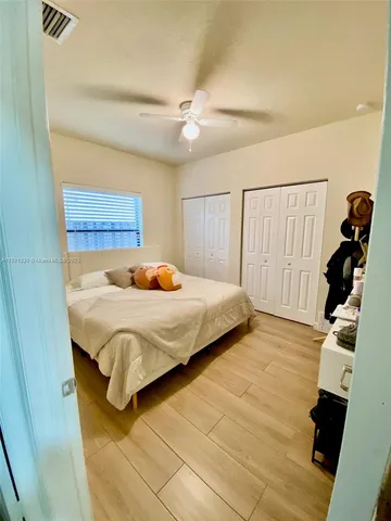 a bedroom with a bed and a mirror