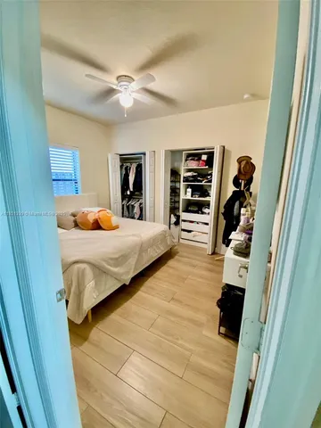 a bedroom with furniture and a flat screen tv