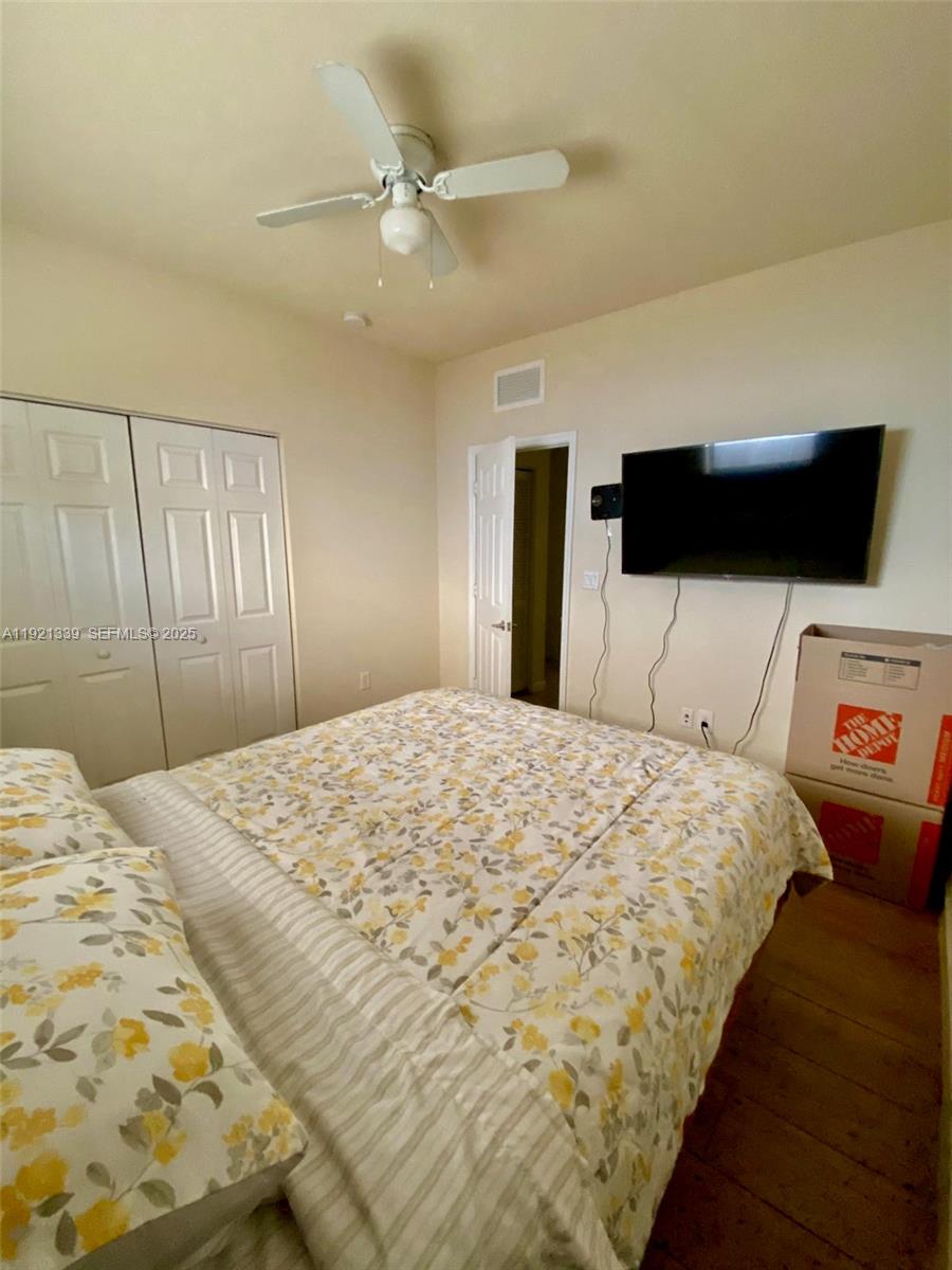 4318 Southwest 164th Court Miami, FL 33185 - Photo 18 of 27 a bedroom with a bed and a flat tv screen on dresser