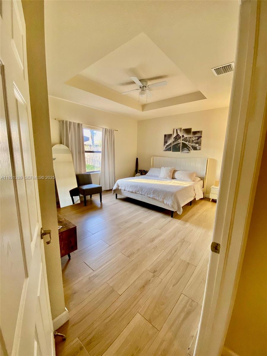 4318 Southwest 164th Court Miami, FL 33185 - Photo 19 of 27 a bedroom with a bed and wooden floor