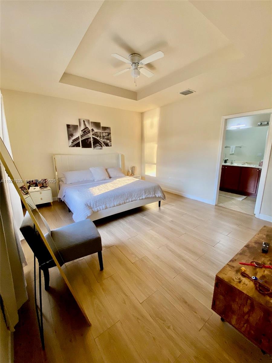 4318 Southwest 164th Court Miami, FL 33185 - Photo 22 of 27 a bedroom with furniture and a wooden floor