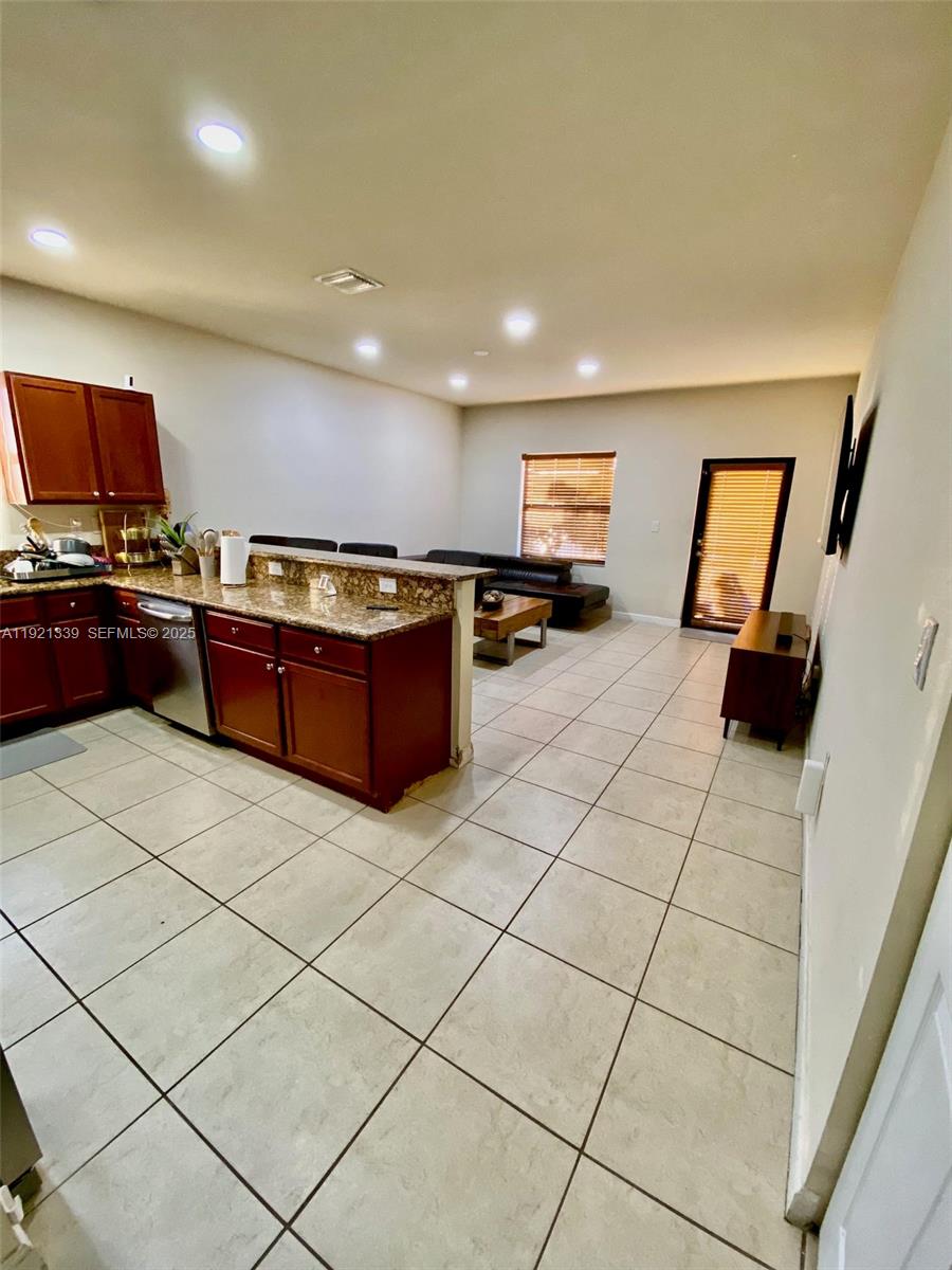 4318 Southwest 164th Court Miami, FL 33185 - Photo 3 of 27 a kitchen with stainless steel appliances a stove a sink a counter top space and cabinets
