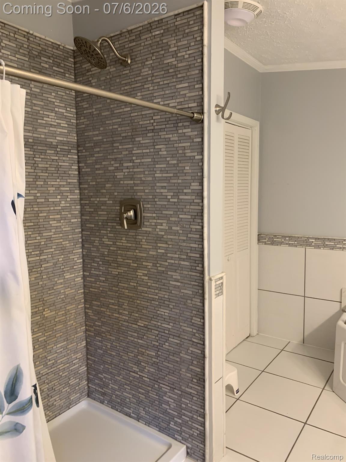4168 Harris Road Fort Gratiot, MI 48059 - Photo 29 of 30 Shower stall featuring variegated rectangular tile surround, rain shower head, and brushed nickel fixtures